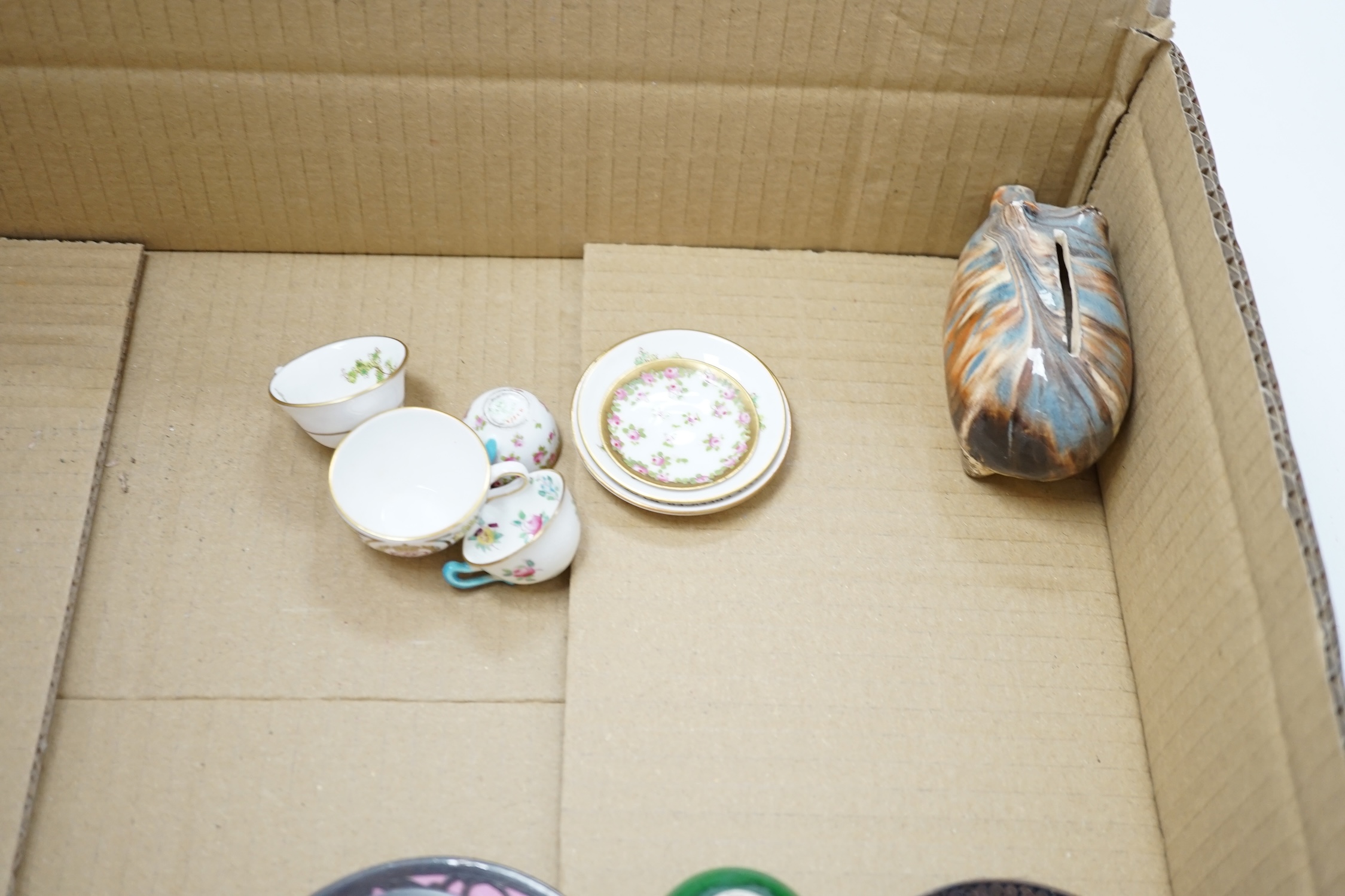 A collection of cabinet curiosities, including miniature cups, an ostrich egg, a Japanese marbled pottery teapot, a sand picture, snowmen cake decorations, etc. (2 trays). Condition - fair to good